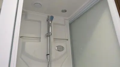 a shower with a glass door in a bathroom at Y's INN Oyama 021T in Tokyo