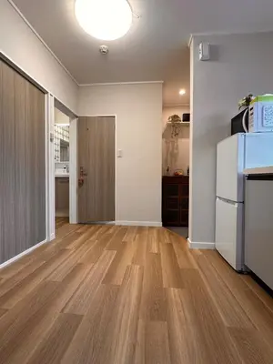 an empty living room with a refrigerator and a kitchen at \u516b\u5e83101Nearby Tokyo Skytree in Tokyo