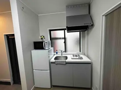 a small kitchen with a sink and a refrigerator at \u516b\u5e83101Nearby Tokyo Skytree in Tokyo