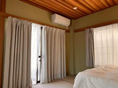 a bedroom with a bed and a window with curtains at 八広301 Nearby Tokyo Skytree & Asakusa in Tokyo