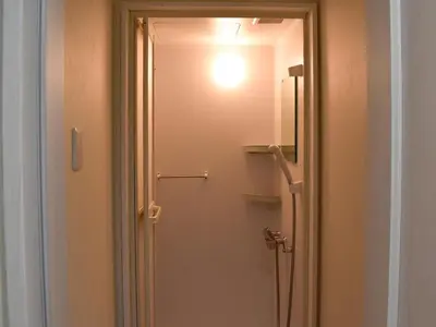 a door to a bathroom with a light on it at HOTEL WINDS ASAKUSA Capsule Inn \u6d45\u8349 in Tokyo