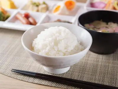 a bowl of rice sitting on a table with chopsticks at Super Hotel Tokyo JR Kamata Nishiguchi in Tokyo