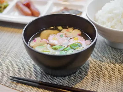 a bowl of food on a table with rice and chopsticks at Super Hotel Tokyo JR Kamata Nishiguchi in Tokyo