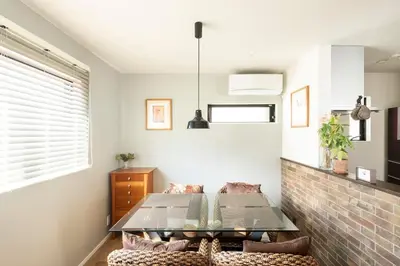 a living room with a table and a couch at Zuzu & Gizmo in Tokyo
