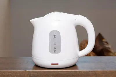 a white electric kettle sitting on a table at Zuzu & Gizmo in Tokyo
