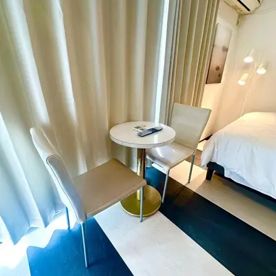 a small table and chairs in a room with a bed at ookubo hills Room for 2 located in Shinjuku area in Tokyo