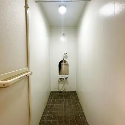 a small bathroom with a shower in the wall at ookubo hills Room for 2 located in Shinjuku area in Tokyo