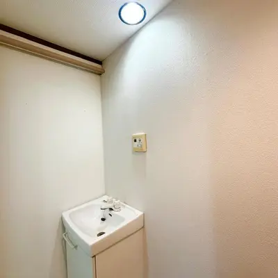 a bathroom with a toilet and a sink and a light at ookubo hills Room for 2 located in Shinjuku area in Tokyo