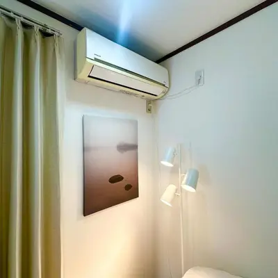 a bathroom with a heater and a picture on the wall at ookubo hills Room for 2 located in Shinjuku area in Tokyo