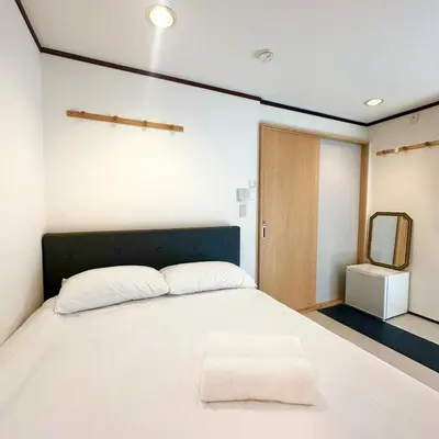 a bedroom with a white bed and a mirror at ookubo hills Room for 2 located in Shinjuku area in Tokyo