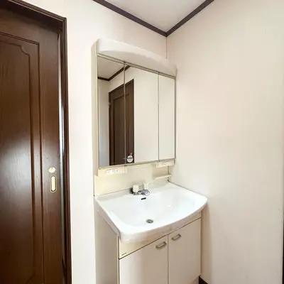 a bathroom with a white sink and a mirror at ookubo hills Unique 3 Bedroom House in Shinjuku area in Tokyo