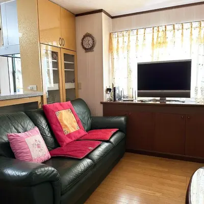 a living room with a leather couch with pillows on it at ookubo hills Unique 3 Bedroom House in Shinjuku area in Tokyo