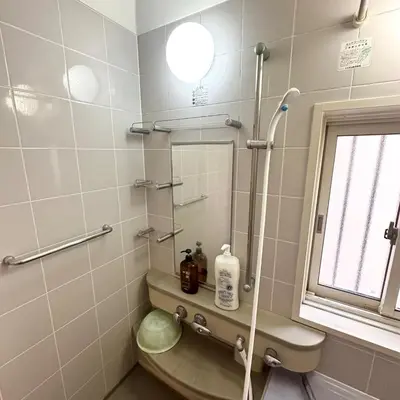 a bathroom with a shower and a toilet and a window at ookubo hills Unique 3 Bedroom House in Shinjuku area in Tokyo