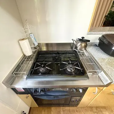 a stove top oven with a pot on top of it at ookubo hills Unique 3 Bedroom House in Shinjuku area in Tokyo