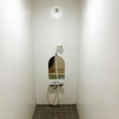a bathroom with a shower in a white wall at ookubo hills Room for 1 located in Shinjuku area in Tokyo