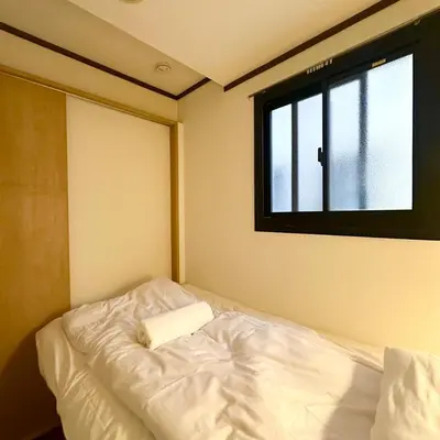 a white bed in a room with a window at ookubo hills Room for 1 located in Shinjuku area in Tokyo