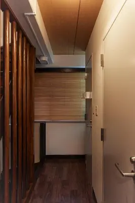 a hallway with a window with wooden blinds in a room at Asakusa Premium Stay \u5f69-Irodori- in Tokyo