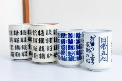 a row of blue and white cups sitting on a shelf at The Guest House Nagomi in Tokyo