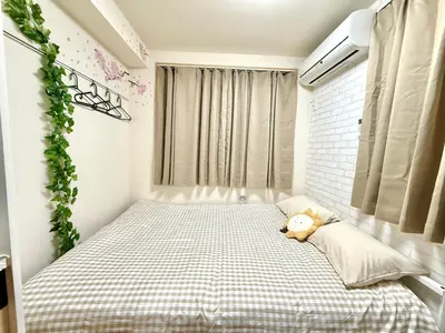 a bedroom with a bed with a teddy bear on it at Shinjuku Cloudlive AE AF in Tokyo