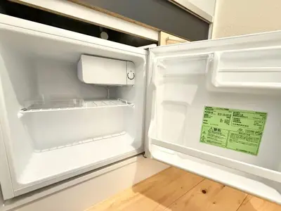 an empty refrigerator with its door open in a kitchen at Shinjuku Cloudlive AE AF in Tokyo