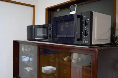 two microwaves sitting on top of a counter at Lucky house west Kitasenju in Tokyo