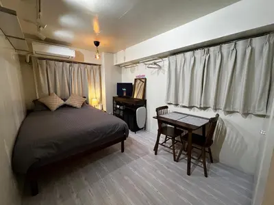 a bedroom with a bed and a table and a desk at SHINJUKU station 10min by walk! KB House in Tokyo