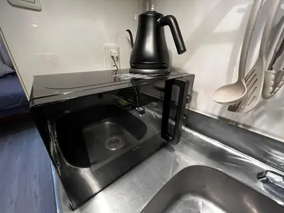 a kitchen sink with a coffee maker on top of it at SHINJUKU station 10min by walk! KB House in Tokyo