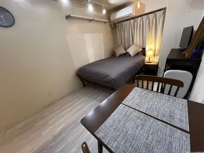 a small room with a bed and a table at SHINJUKU station 10min by walk! KB House in Tokyo