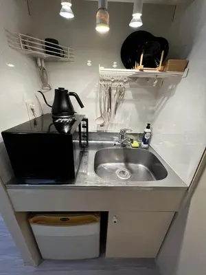 a kitchen sink with a kettle on top of it at SHINJUKU station 10min by walk! KB House in Tokyo