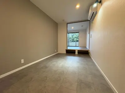 an empty room with a large window and a tile floor at COTO Shibuya Premium Garden in Tokyo