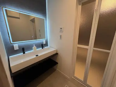a bathroom with a sink and a mirror at COTO Shibuya Premium Garden in Tokyo