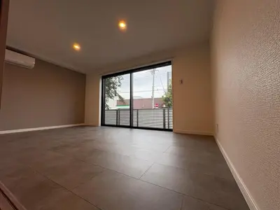 an empty room with a large glass door to a balcony at COTO Shibuya Premium Garden in Tokyo