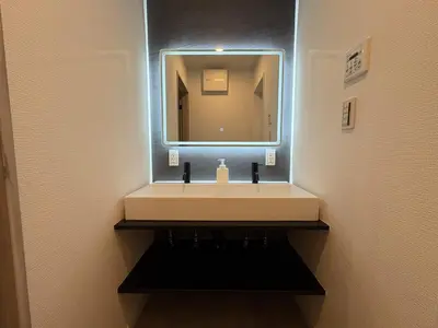 a bathroom with a sink and a mirror at COTO Shibuya Premium Garden in Tokyo