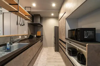 a kitchen with a sink and a microwave at Eims stay Ikebukuro in Tokyo