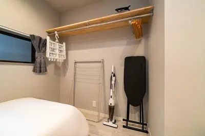 a bedroom with a bed and a tv on the wall at Eims stay Ikebukuro in Tokyo