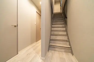 a staircase in a room with a hallway at Eims stay Ikebukuro in Tokyo