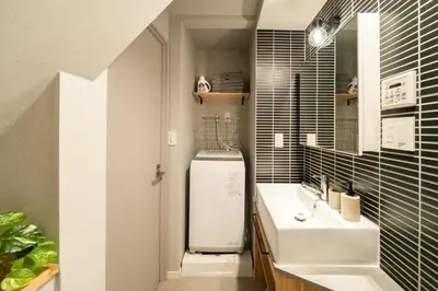 a bathroom with a sink and a refrigerator at Eims stay Ikebukuro in Tokyo