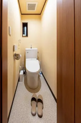 a bathroom with a toilet and a pair of shoes at Nestry \u6d45\u8349 yuuan Sakura102 in Tokyo