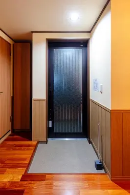 an empty hallway with a door with a window at Nestry \u6d45\u8349 yuuan Sakura102 in Tokyo