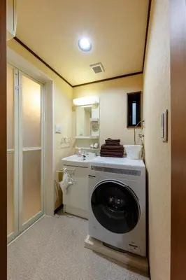 a washing machine in a bathroom with a sink at Nestry \u6d45\u8349 yuuan Sakura102 in Tokyo