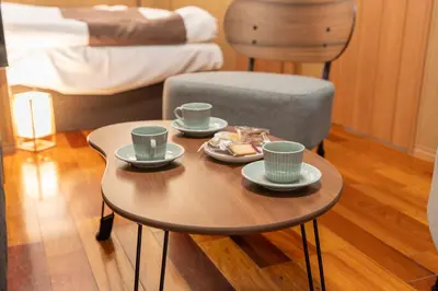 a table with two cups and a plate of food on it at Nestry \u6d45\u8349 yuuan Sakura102 in Tokyo
