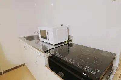 a microwave sitting on top of a kitchen counter at F-Mansion209 in Tokyo