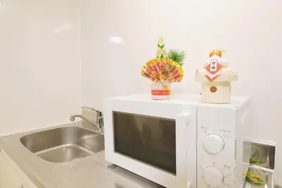 a microwave oven with a sink in a kitchen at F-Mansion209 in Tokyo