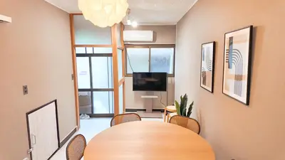 a conference room with a table and chairs and a television at MSTAY\u6771\u6c60\u888bone in Tokyo