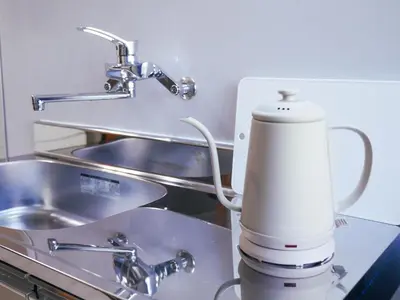 a kitchen counter with a mixer next to a sink at MSTAY\u6771\u6c60\u888bone in Tokyo