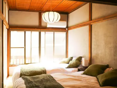 a bedroom with two beds and a large window at MSTAY\u6771\u6c60\u888bone in Tokyo