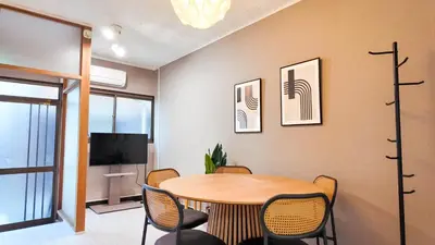 a dining room with a table and chairs and a tv at MSTAY\u6771\u6c60\u888bone in Tokyo