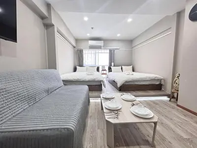 a living room with two beds and a table at Y-Shinjuku City, Okubo 3F-SJ0069 in Tokyo