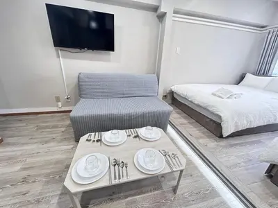 a room with a bed and a table with plates on it at Y-Shinjuku City, Okubo 3F-SJ0069 in Tokyo