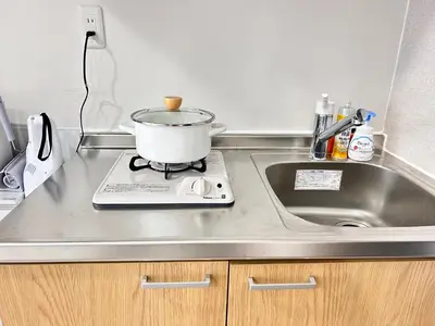a pot sitting on top of a stove next to a sink at Y-Shinjuku City, Okubo 3F-SJ0069 in Tokyo